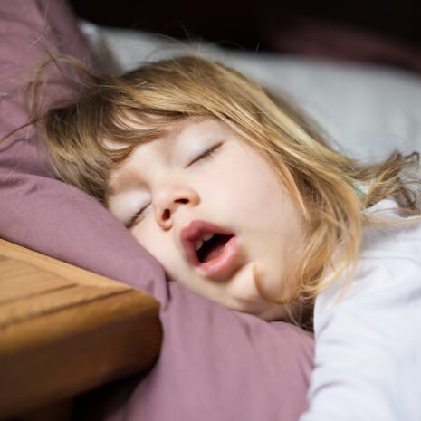 close up of young girl sleeping with her mouth open